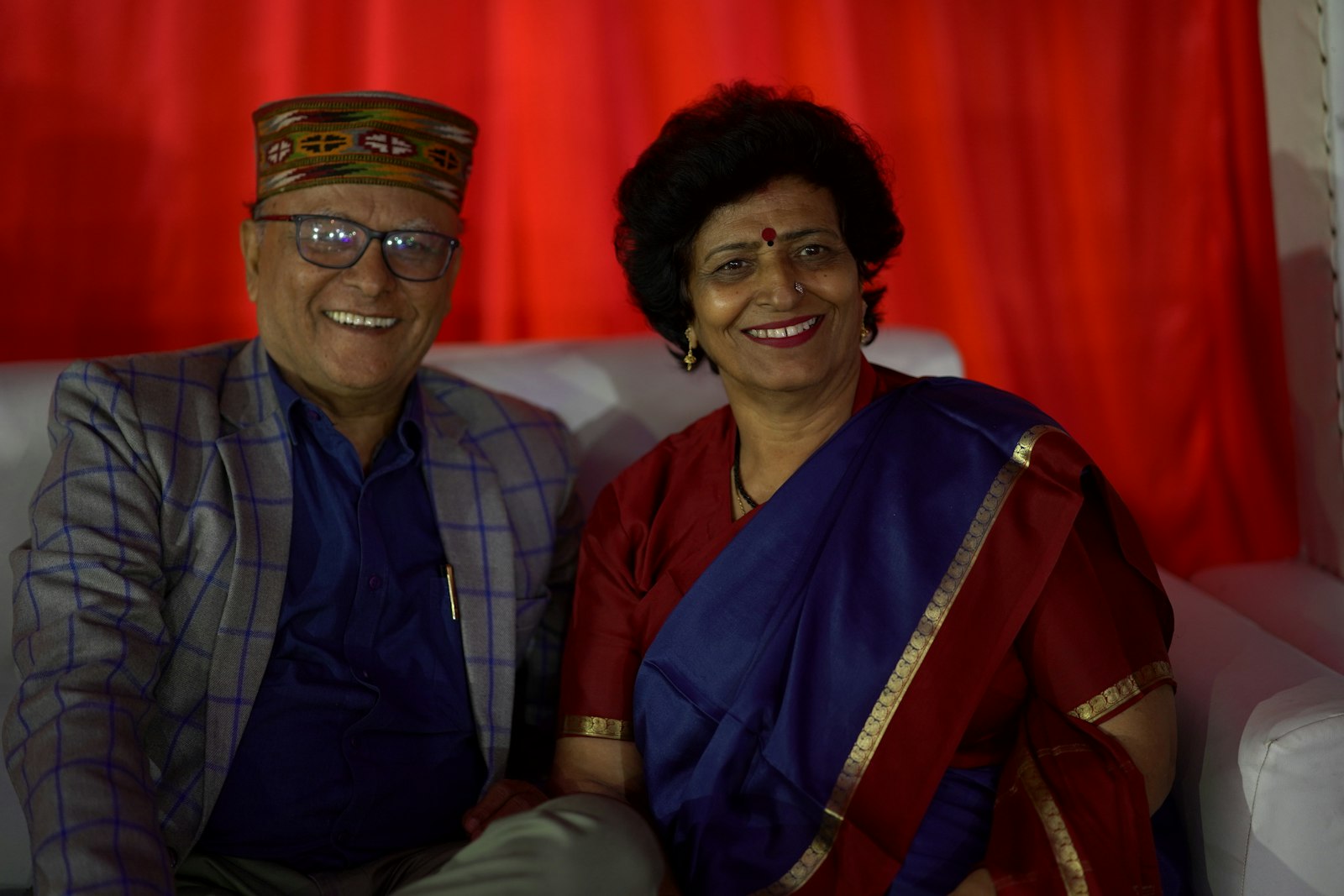 A happy Indian couple in their fifties dressed in traditional attire